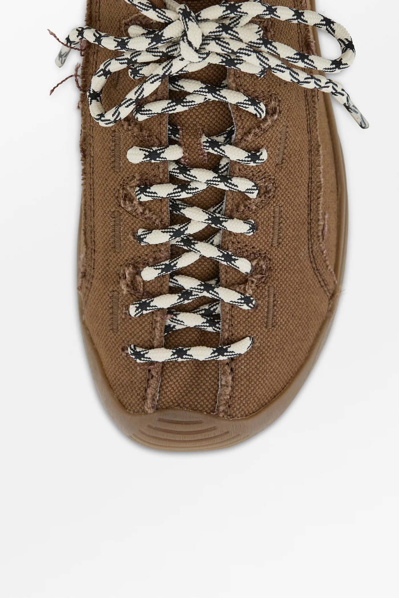 Brown sneaker with white laces on a white background