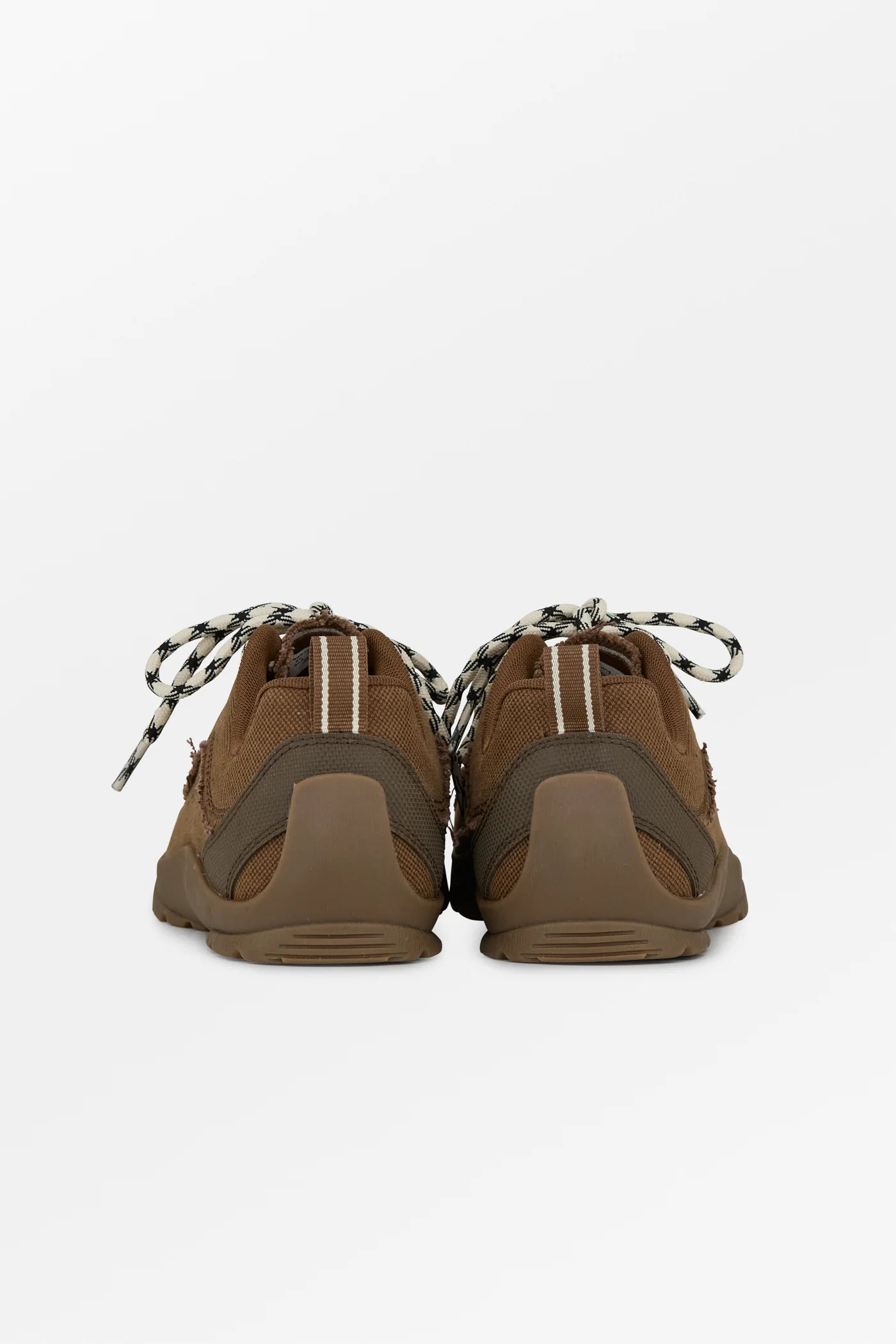 A pair of brown suede and synthetic athletic sneakers shown from the back, featuring brown laces with black and white stripes, dual-density soles, and vertical white stripes on the heel counter.