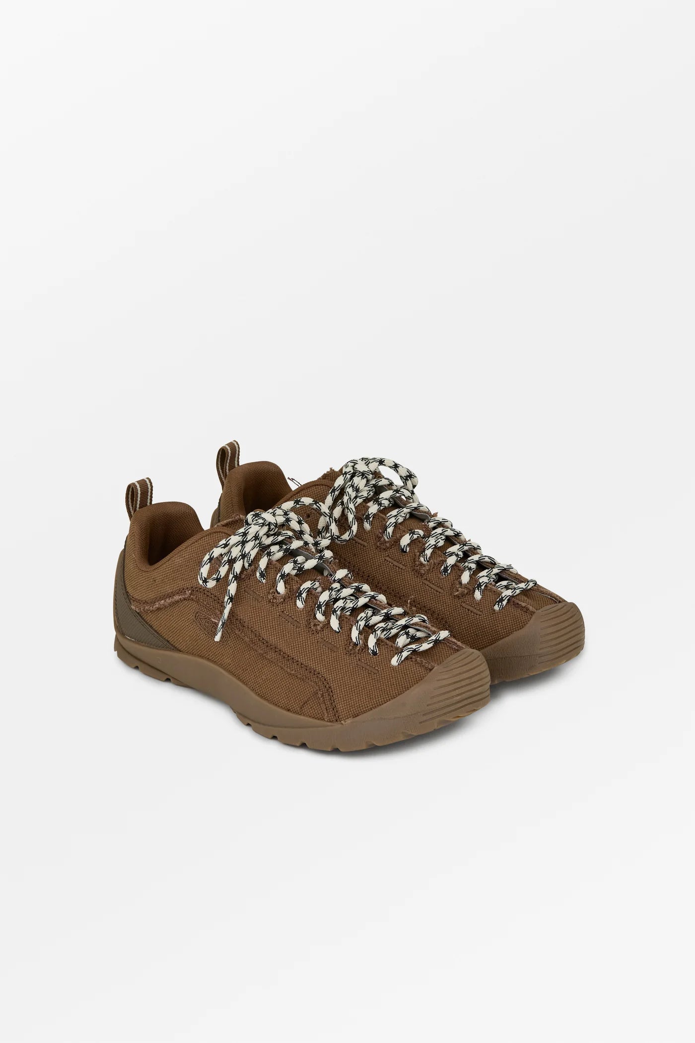 A pair of brown suede sneakers with chunky, chunky braided laces in brown, beige, and white, shown on a light gray background.