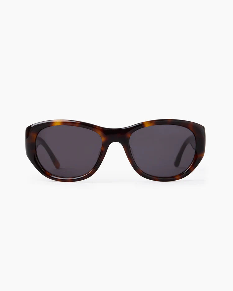 Sunglasses with tortoiseshell frame and dark lenses on a white background