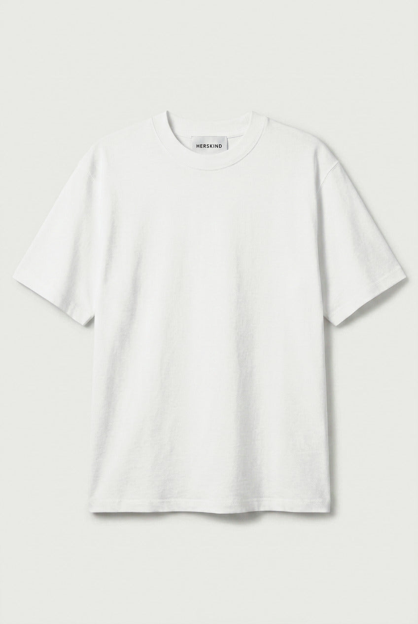 White blouse with 'H&M' branding on a light gray background