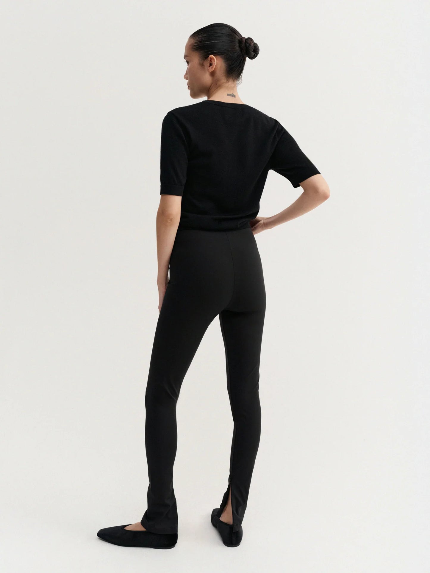 Person wearing a black outfit on a white background
