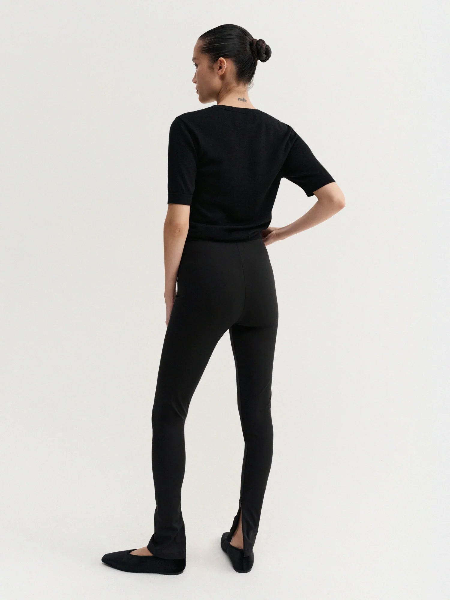 Person wearing a black outfit on a white background
