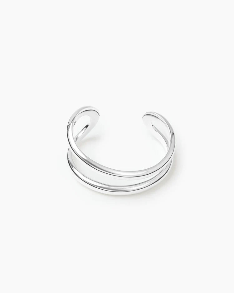 A polished silver-toned double-band cuff bracelet on a clean white background.