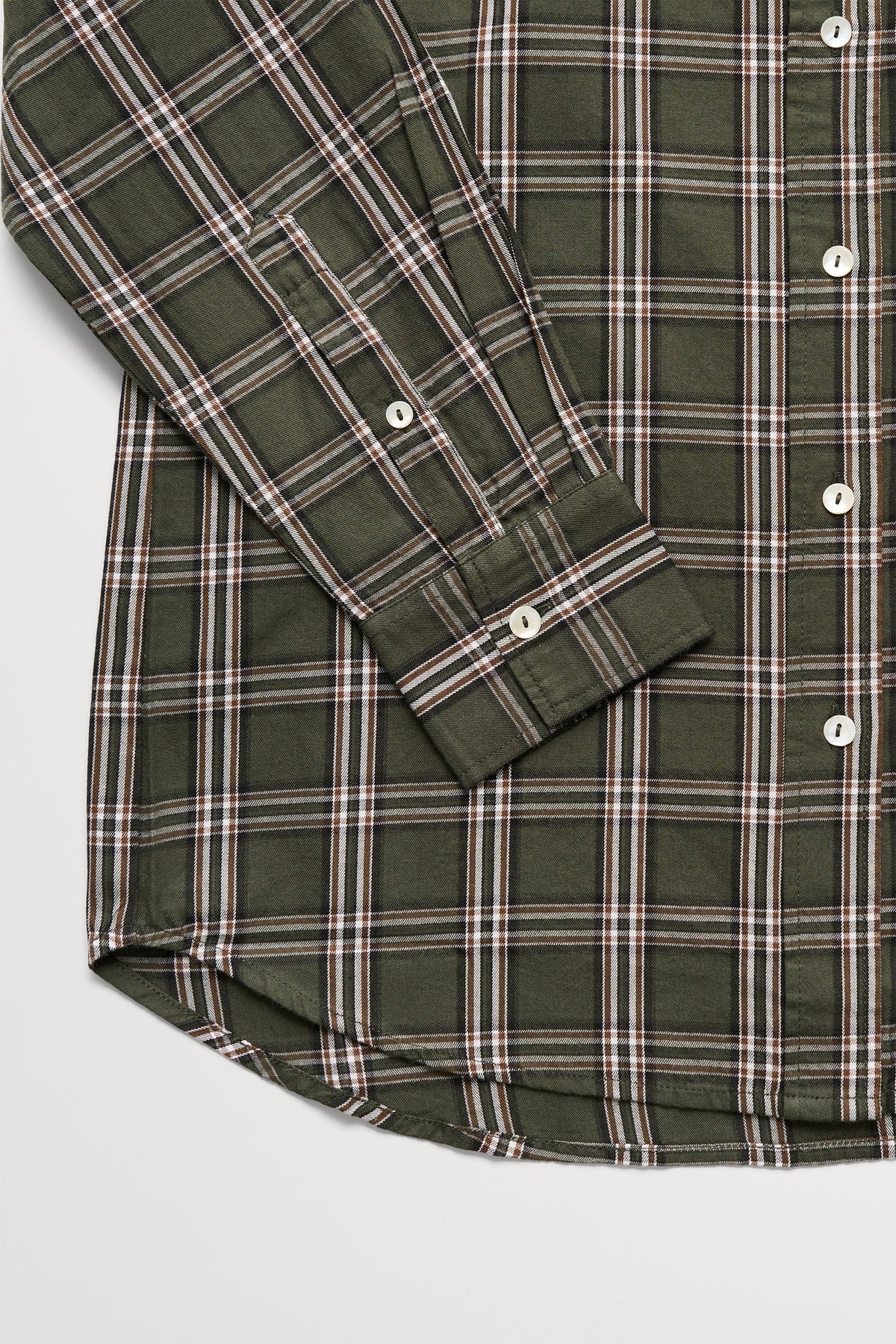 A long-sleeve green and brown plaid button-down shirt in a plain white studio background 