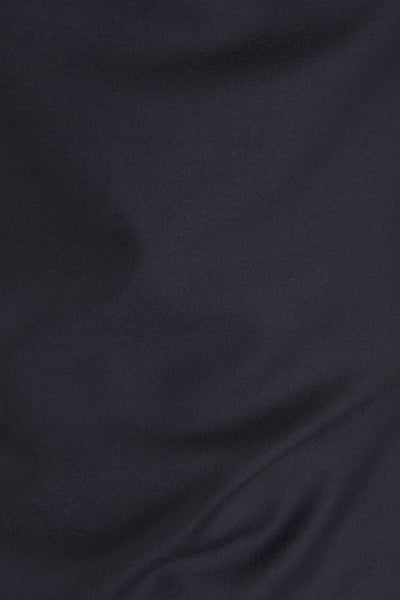 A close-up of dark navy fabric with soft folds and a smooth texture.