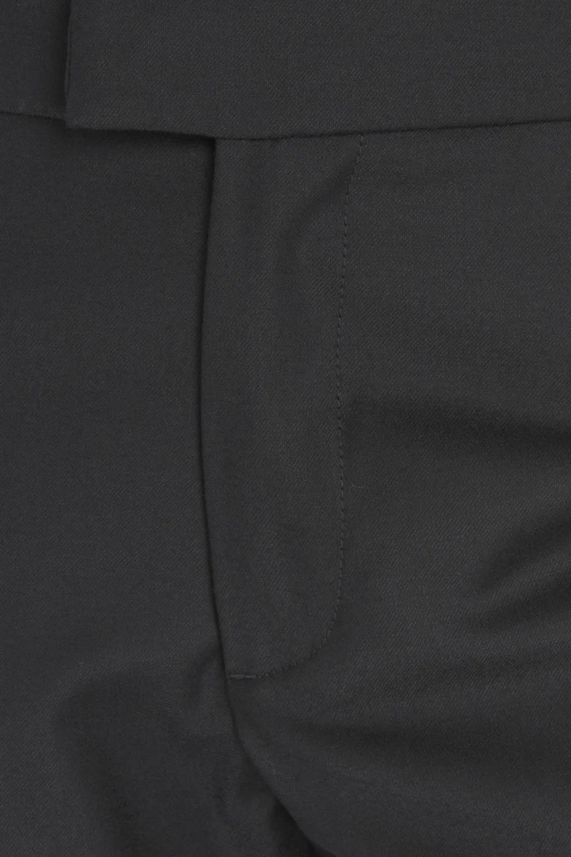 Close-up detail of dark charcoal gray trousers showing the fabric texture, a vertical seam, and a side pocket.