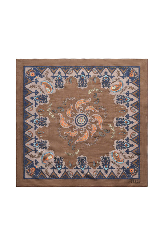 A square scarf with an intricate traditional pattern, featuring a brown center, blue and beige borders, and orange floral accents, displayed flat against a white background.