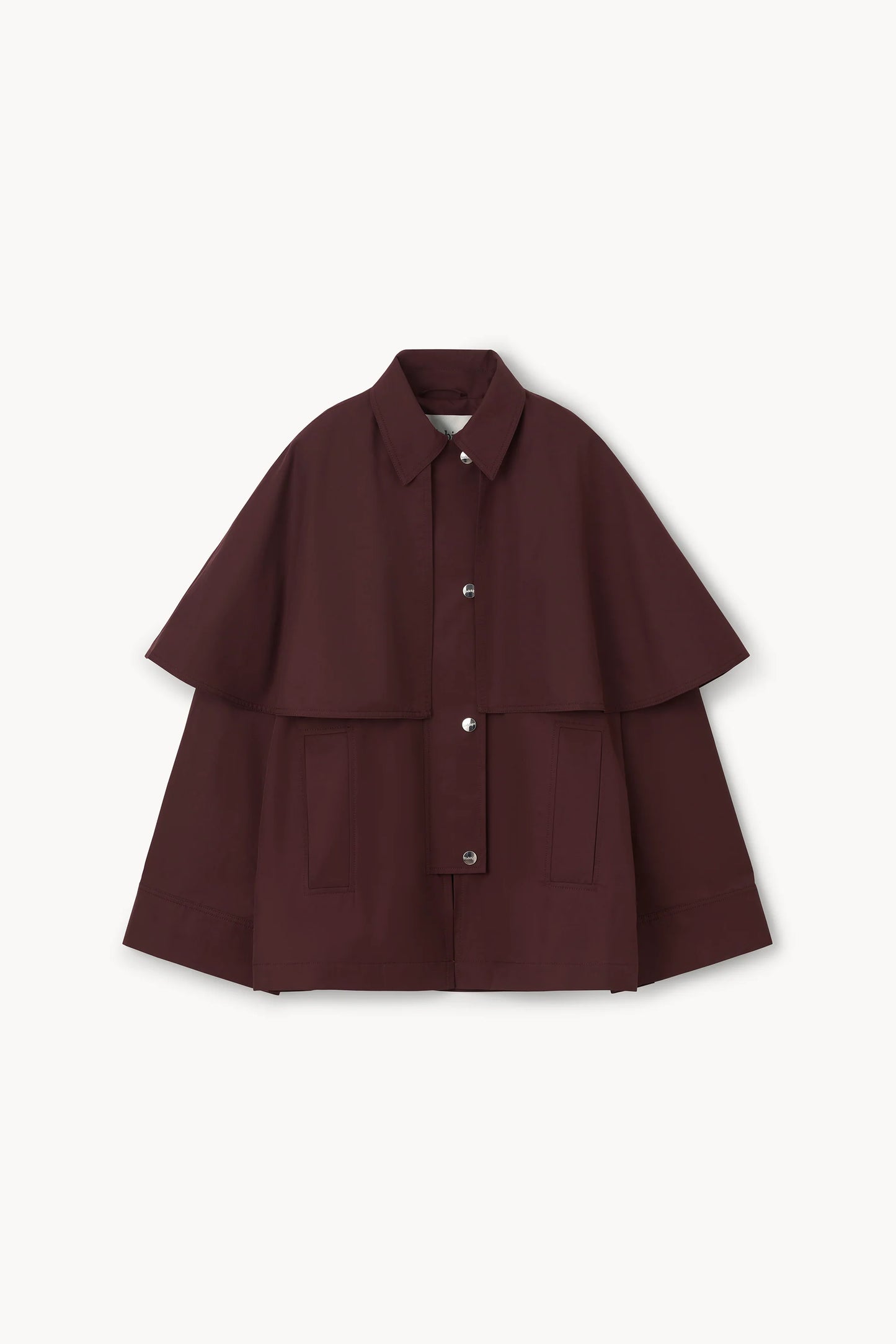 A dark burgundy cape jacket with a collar, button front, and wide layered sleeves, displayed flat against a light off-white background.