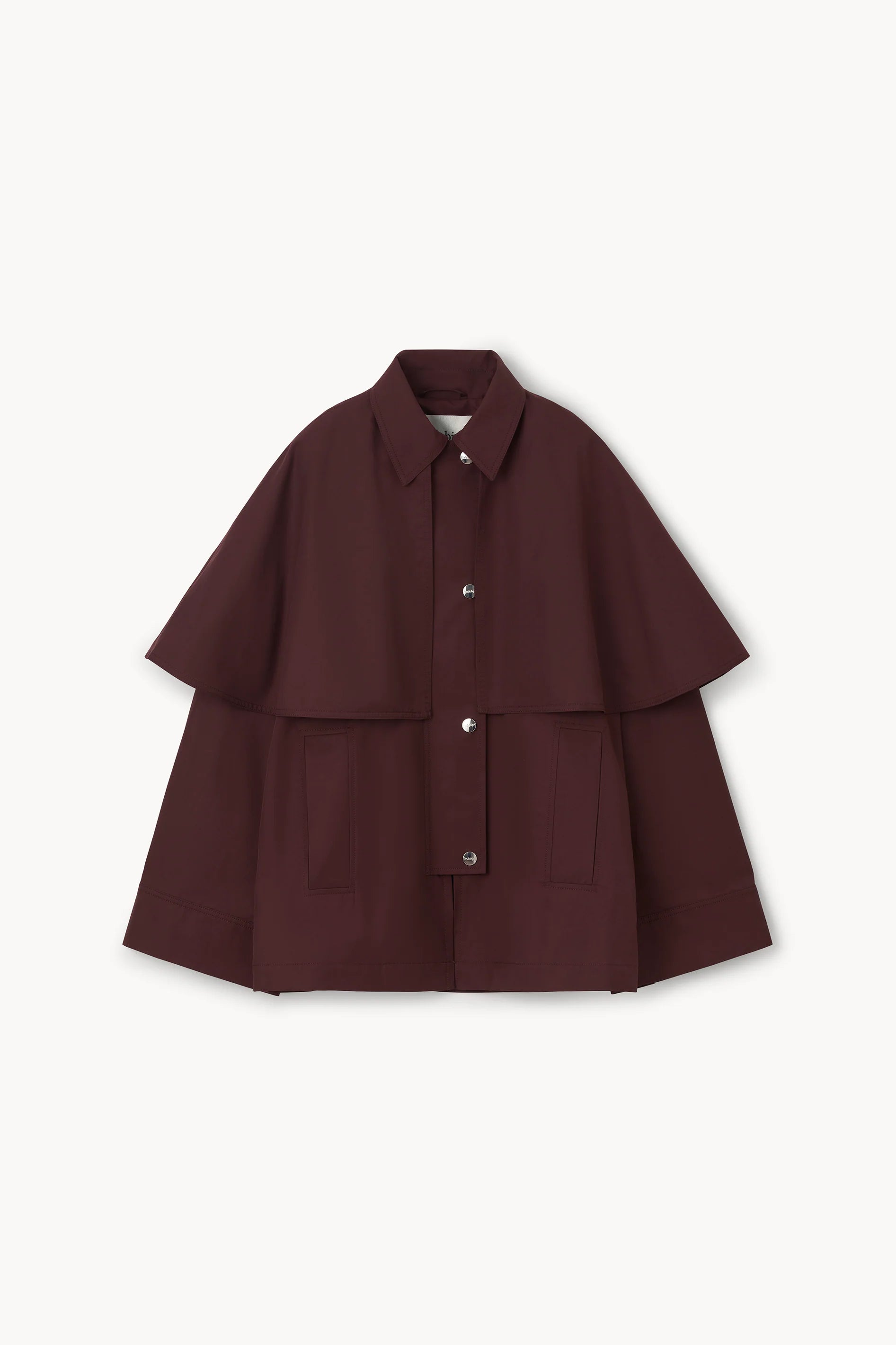 A dark burgundy cape jacket with a collar, button front, and wide layered sleeves, displayed flat against a light off-white background.