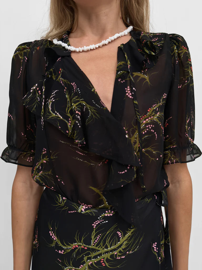 Black floral dress with ruffled details on a white background