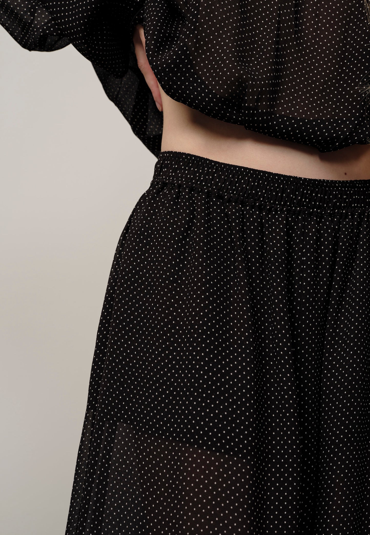 Black polka dot skirt with a plain background
