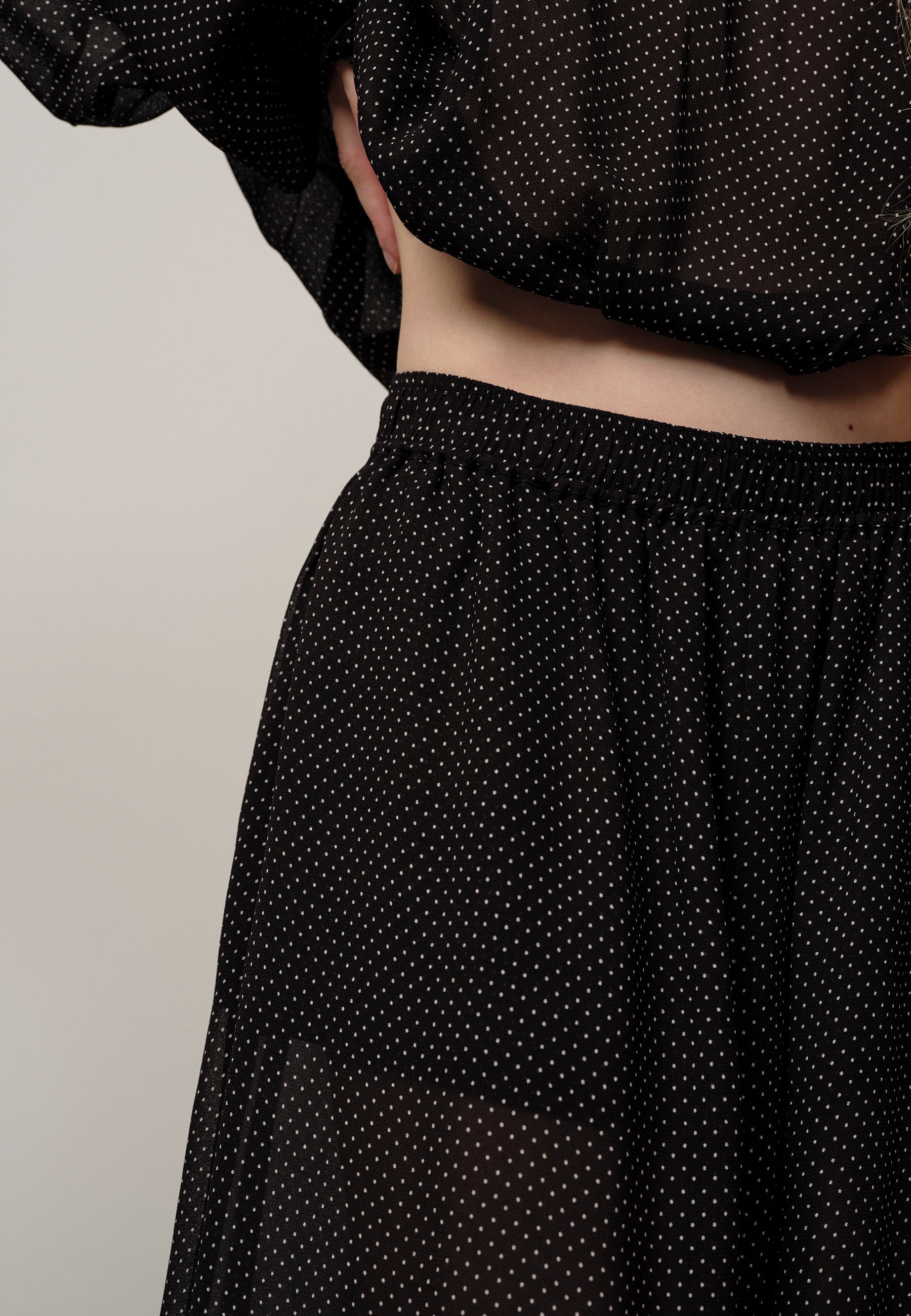 Black polka dot skirt with a plain background