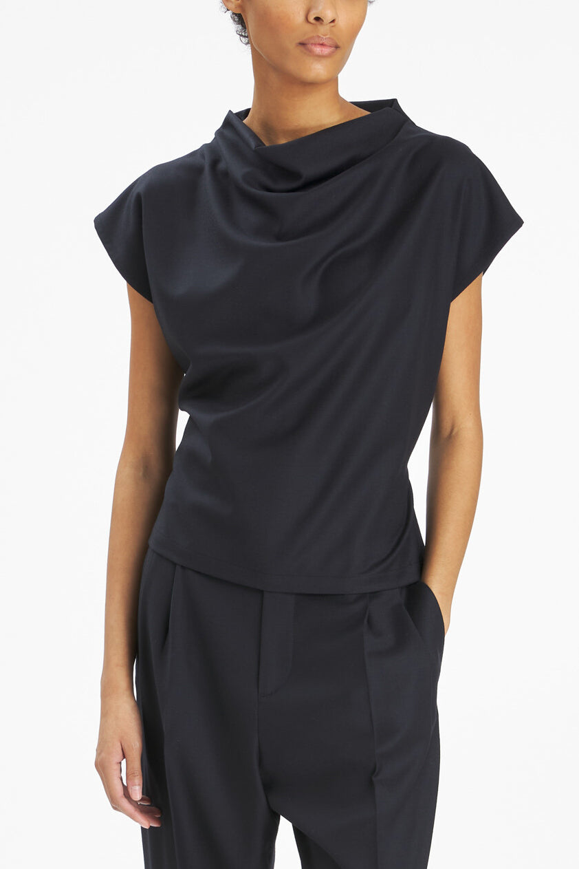 Model with black top with a white background