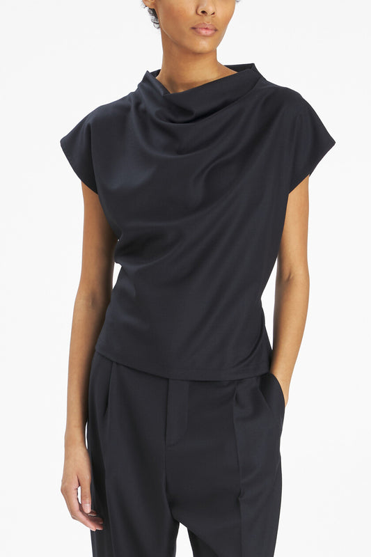 Model with black top with a white background