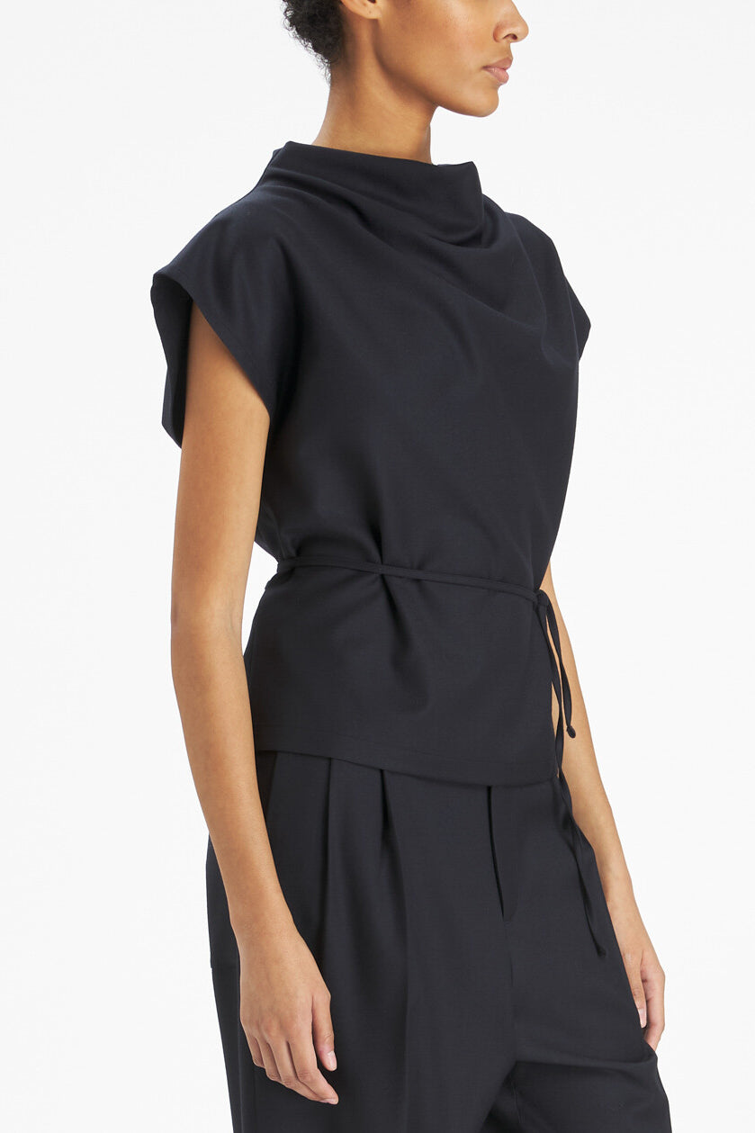Model with black top with a white background