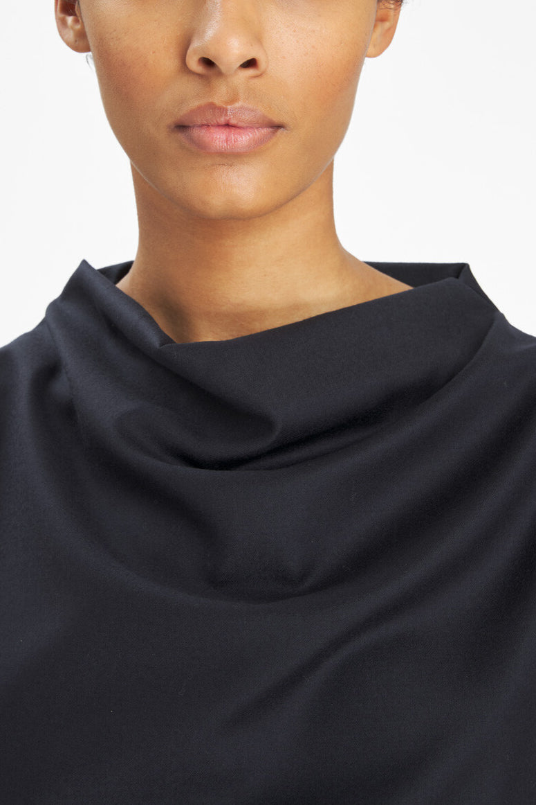 Model with black top with a white background