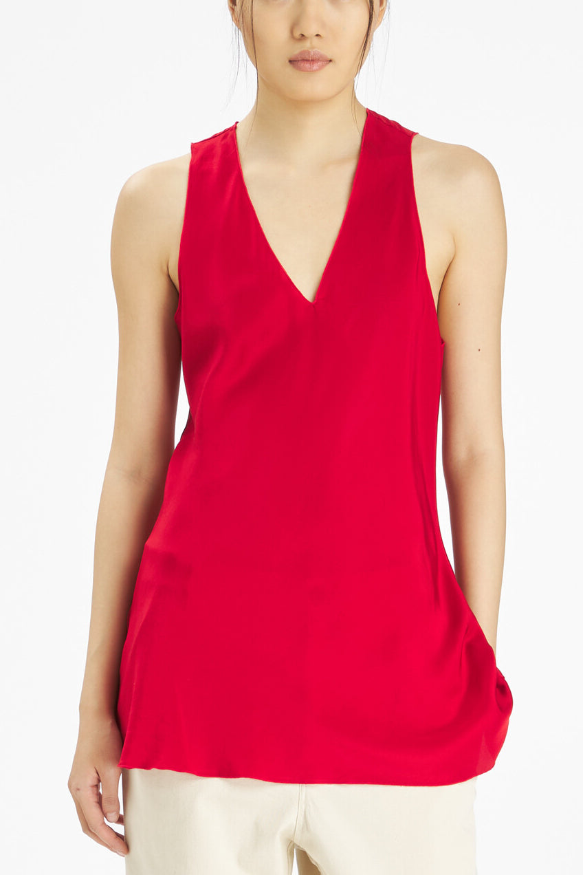 A sleeveless red top with a deep V-neckline, worn by a model against a plain white background.