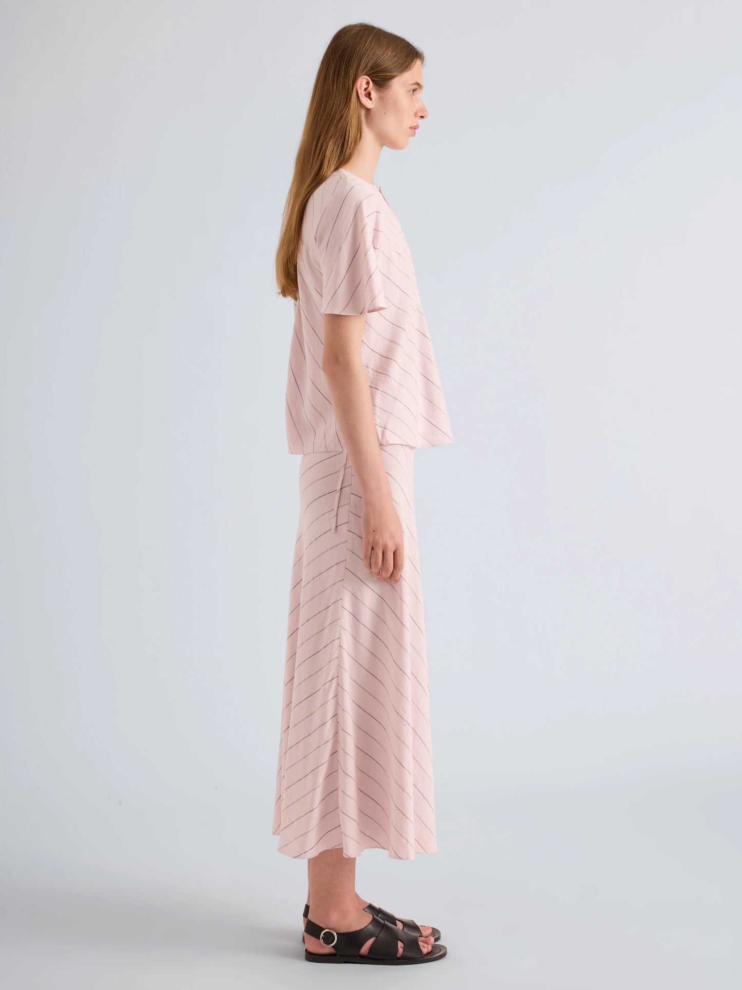 Woman wearing a pink outfit with a white background