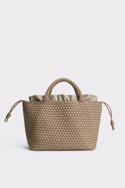 A beige woven straw tote bag with a ruffled fabric lining and matching rope handles, shown against a light gray background.