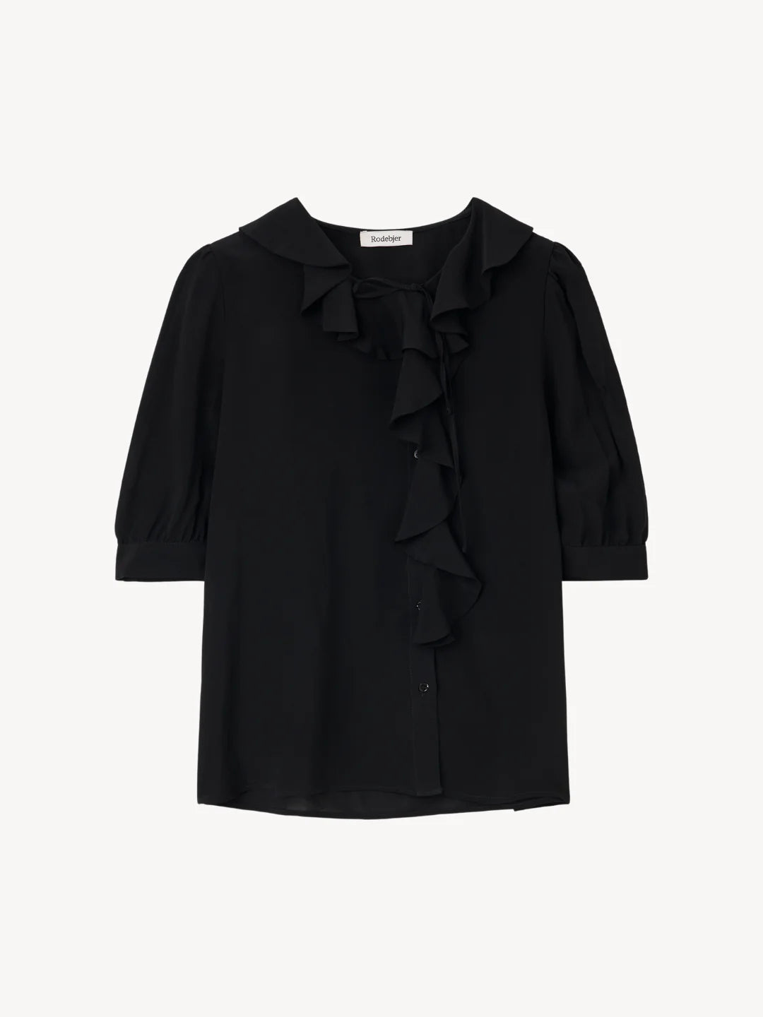 A black long-sleeve blouse with a ruffled Peter Pan collar, bow detail at the neckline, and cascading ruffles down the front center, shown against a plain light background.