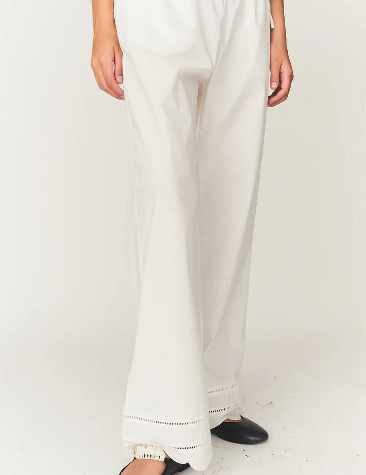 White pants with lace trim on a white background