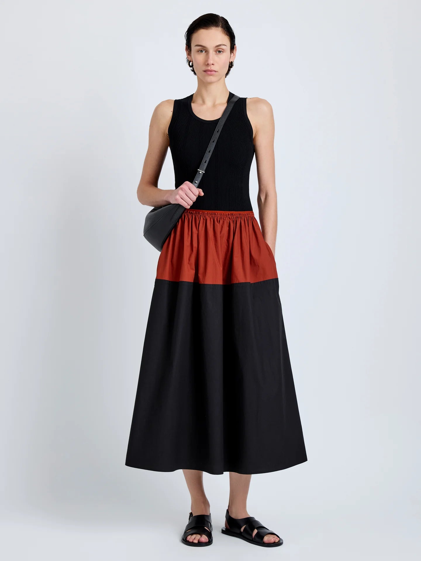 Woman wearing a black and red dress with a white background