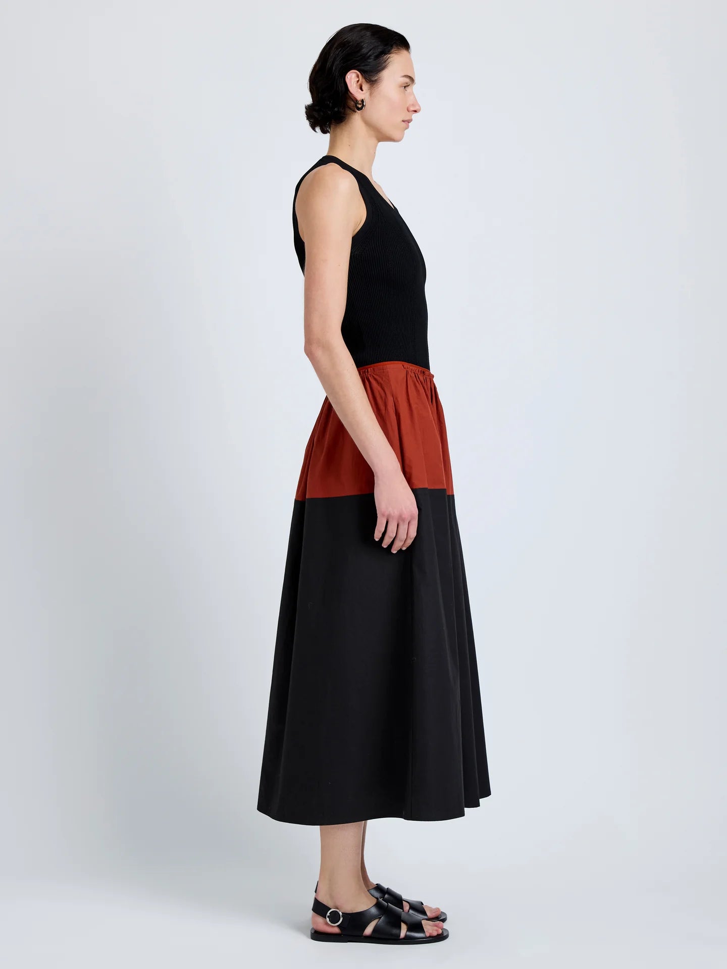 Woman wearing a black and red dress on a white background