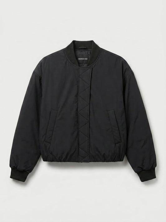 A black quilted bomber jacket with a ribbed collar, cuffs, and hem, featuring a diamond-quilted front panel and side pockets, shown against a light gray background.