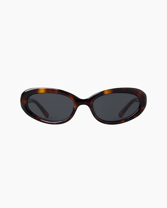 Sunglasses with tortoiseshell frame and dark lenses on a white background