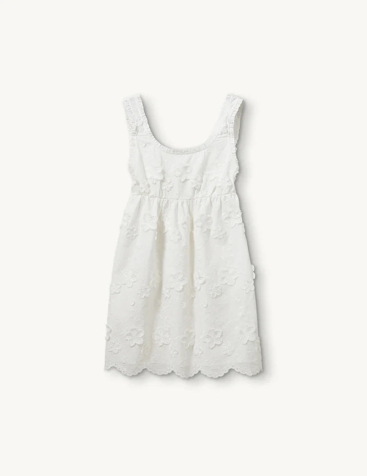 White sleeveless dress with floral details on a white background