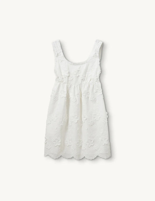 White sleeveless dress with floral details on a white background
