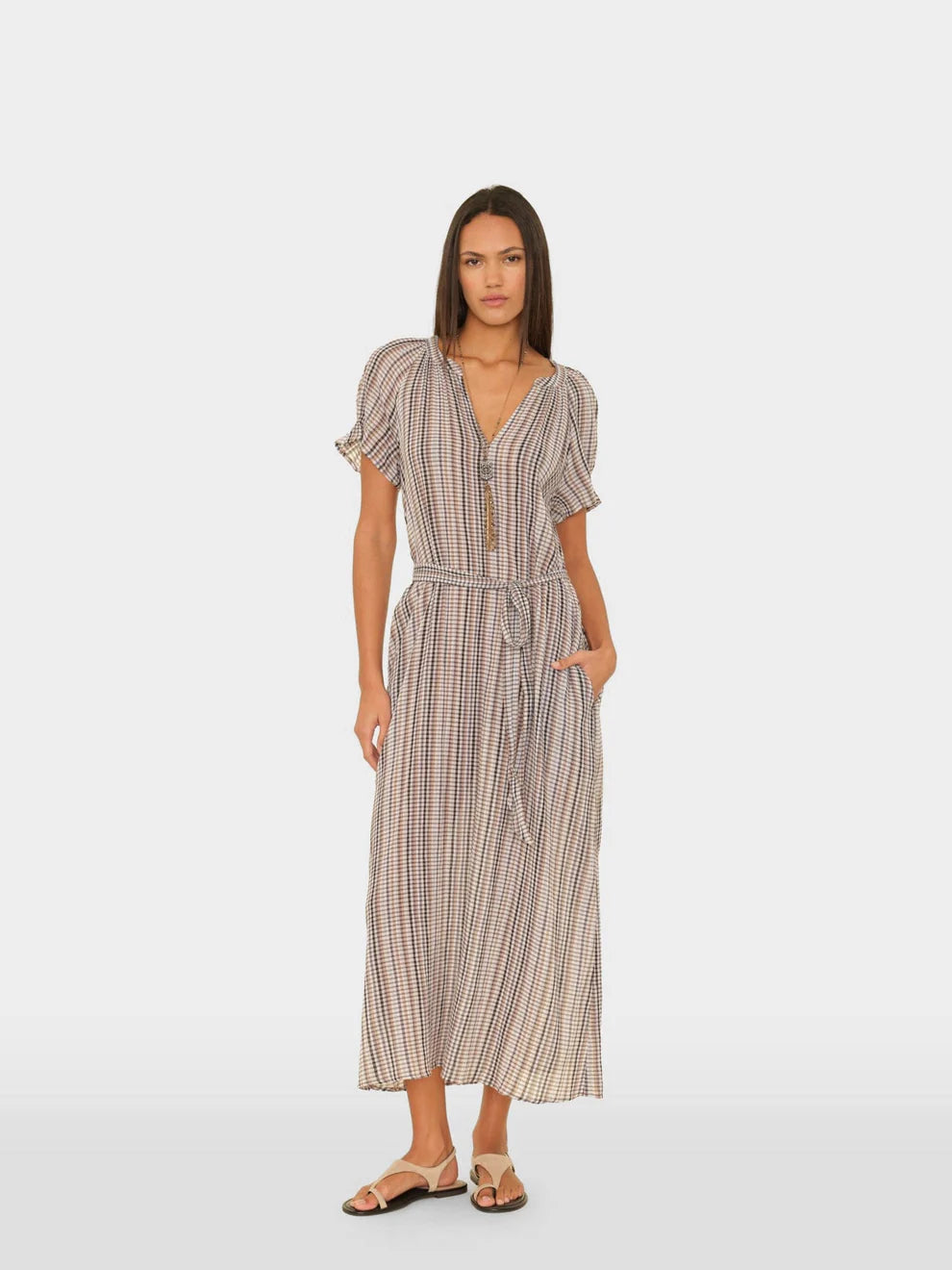 Woman wearing a patterned dress on a white background