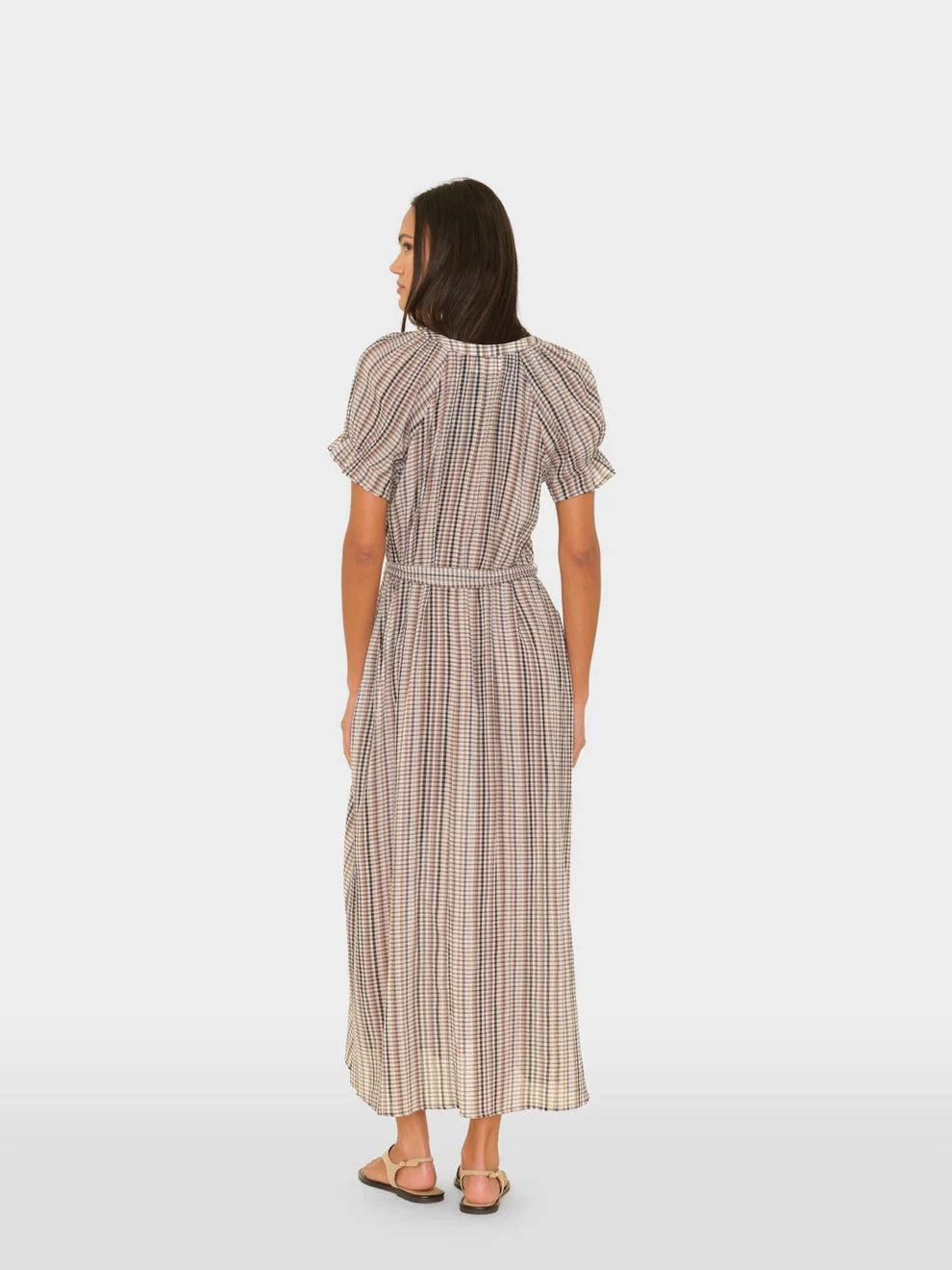 Woman wearing a plaid dress on a white background