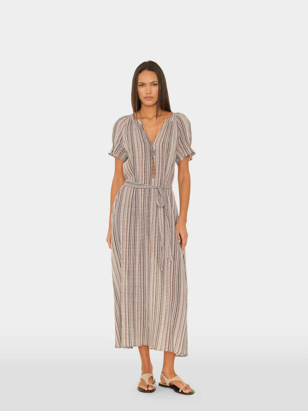 Woman wearing a striped dress on a white background