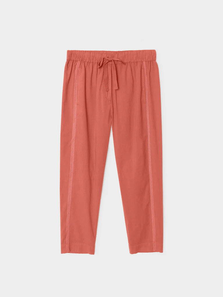 Coral-colored pants on a light gray background
