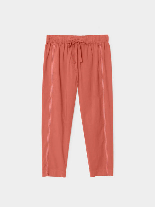 Coral-colored pants on a light gray background