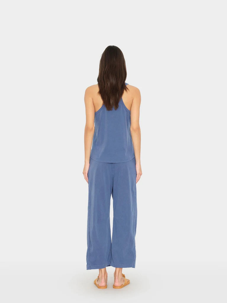 Woman wearing a blue jumpsuit on a white background