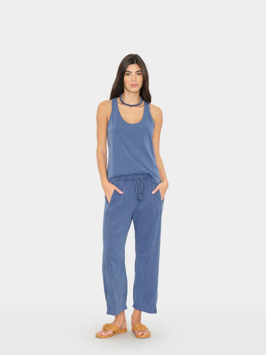 Woman wearing a blue jumpsuit on a white background